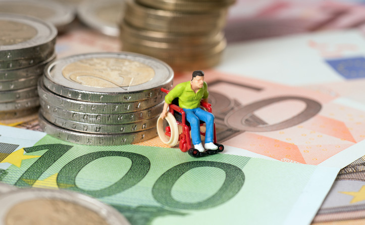 wheelchair users on a stack of coins with euro banknotes